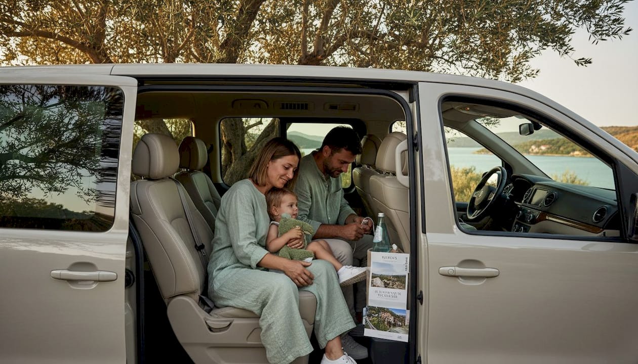 Family enjoying private van comfort by coast