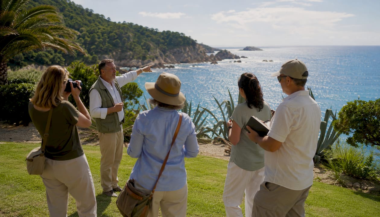 Local guide sharing history with tourists outdoors