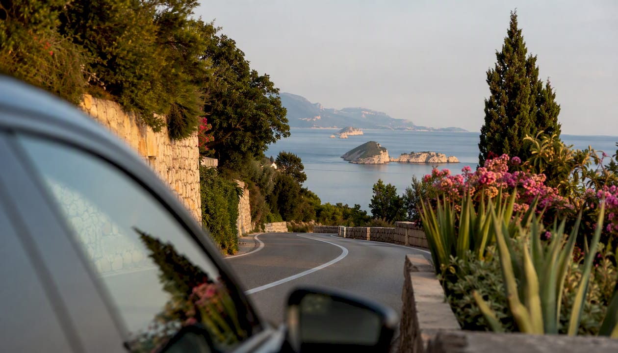Scenic coastal road with luxury vehicle edge