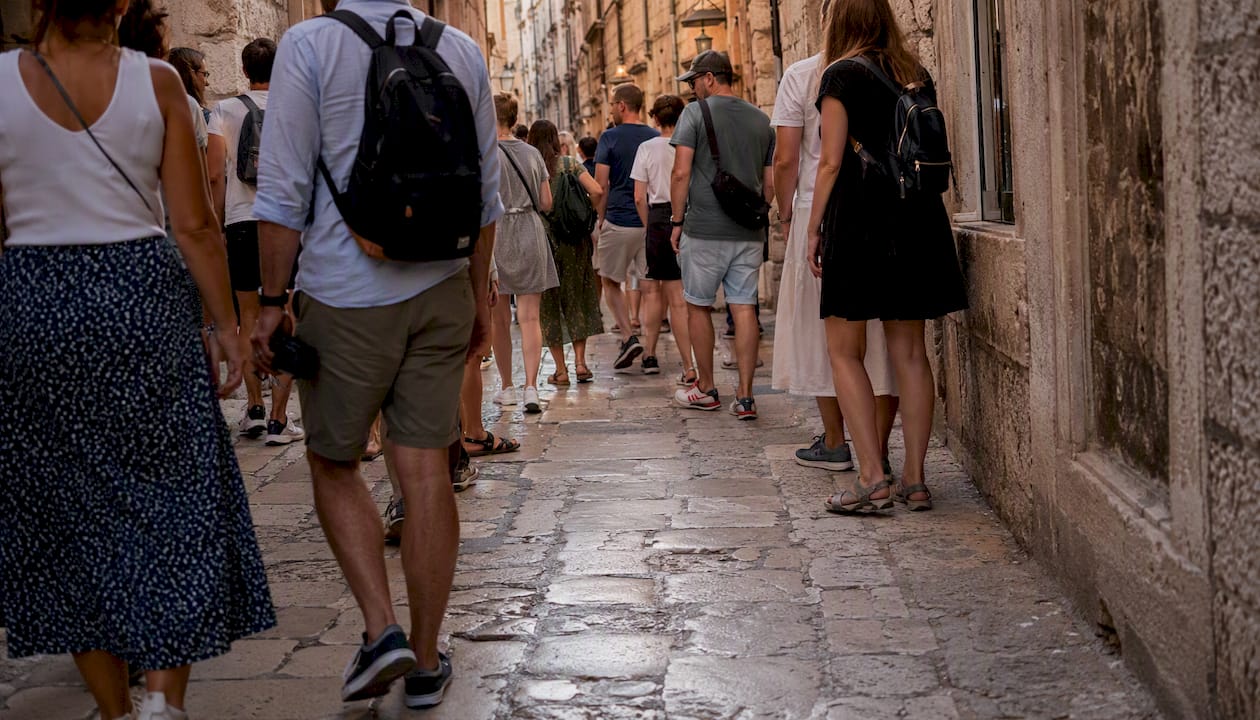 Worn cobblestone street crowded with tourists
