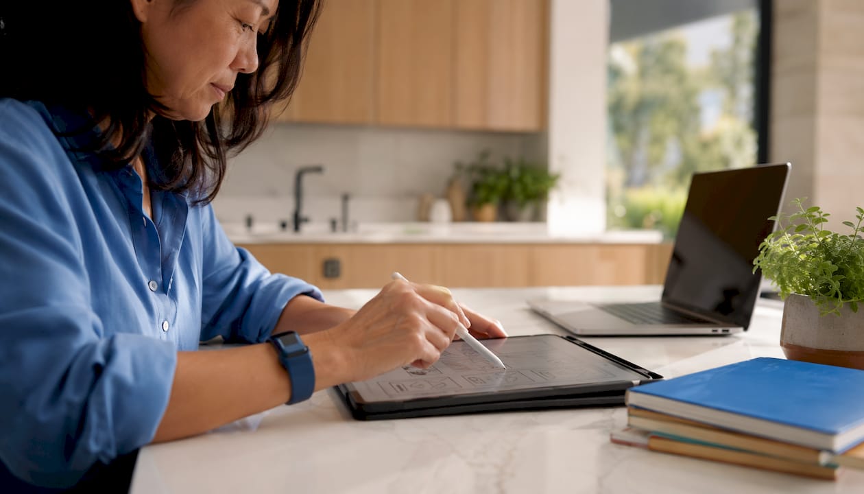 Hands testing website conversion improvements on tablet