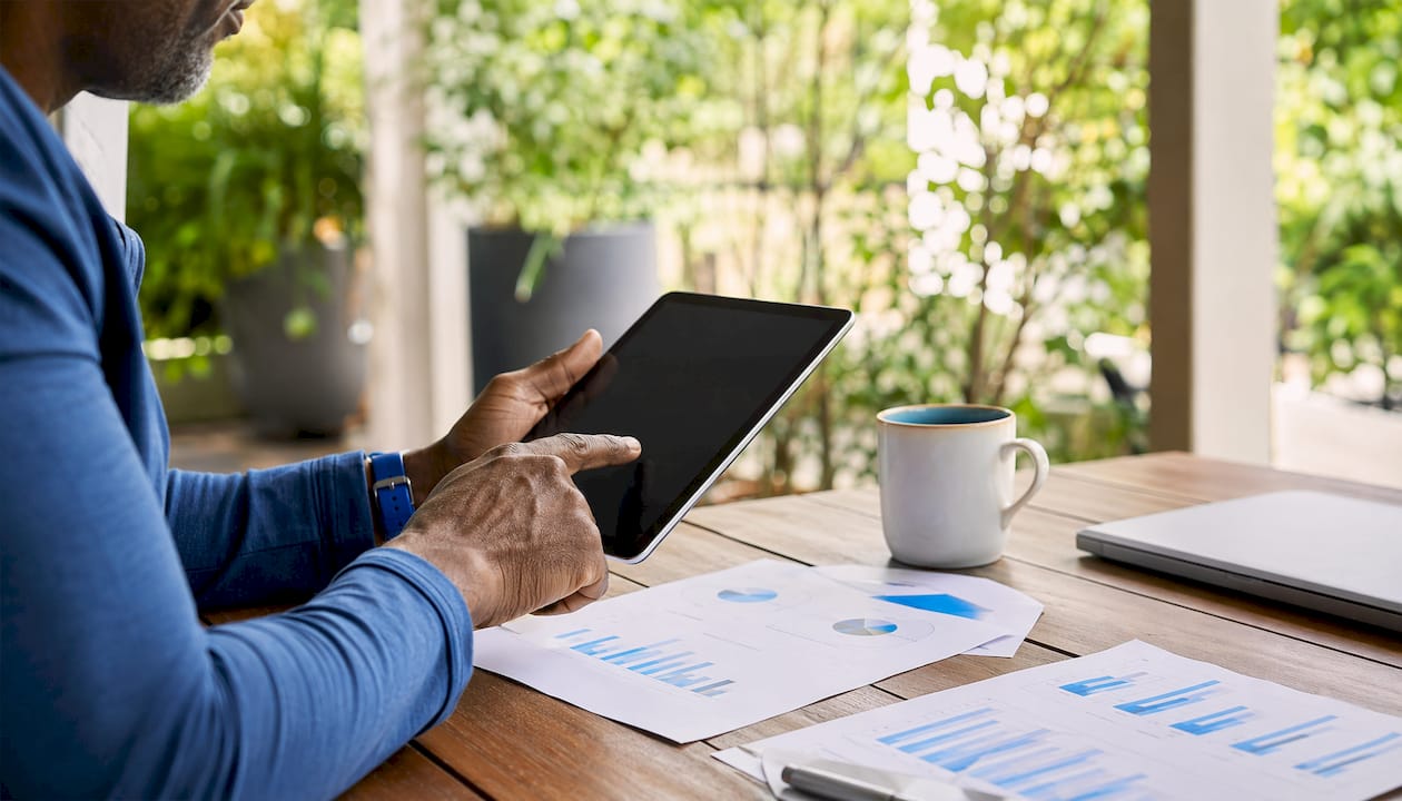 Close-up of hands using tablet during SEO performance review
