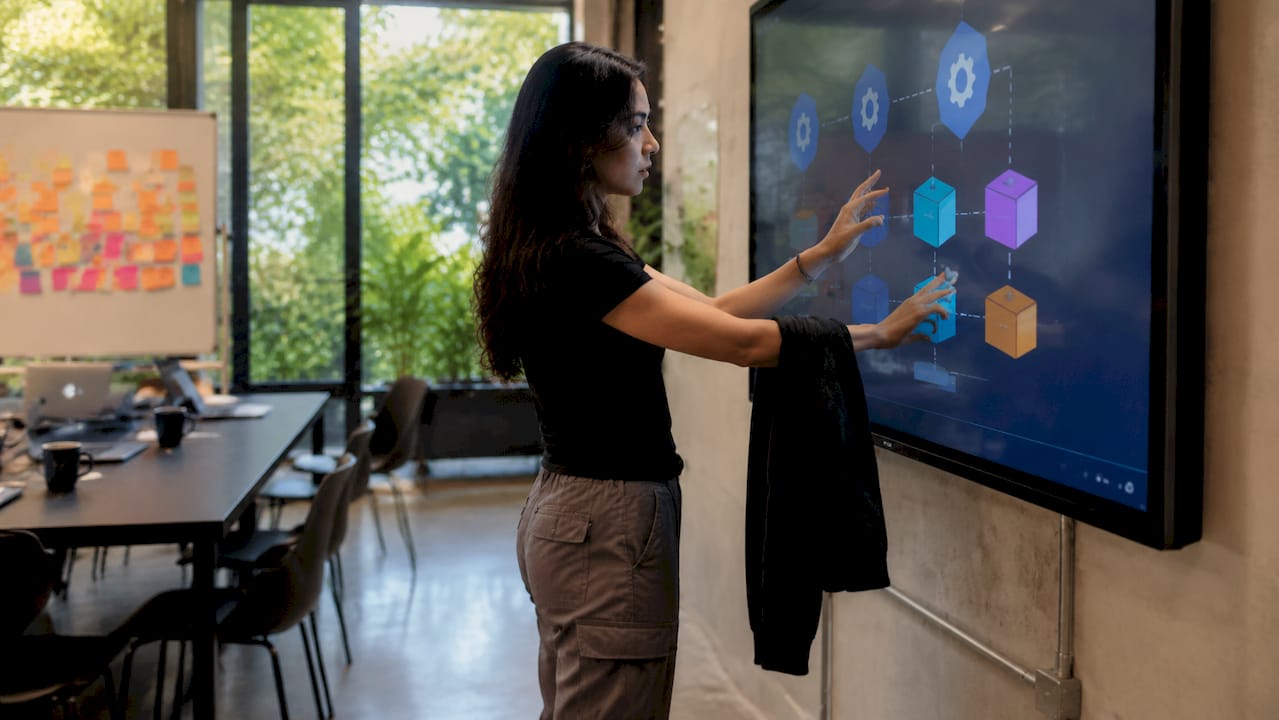 DevOps engineer managing containers on touchscreen table