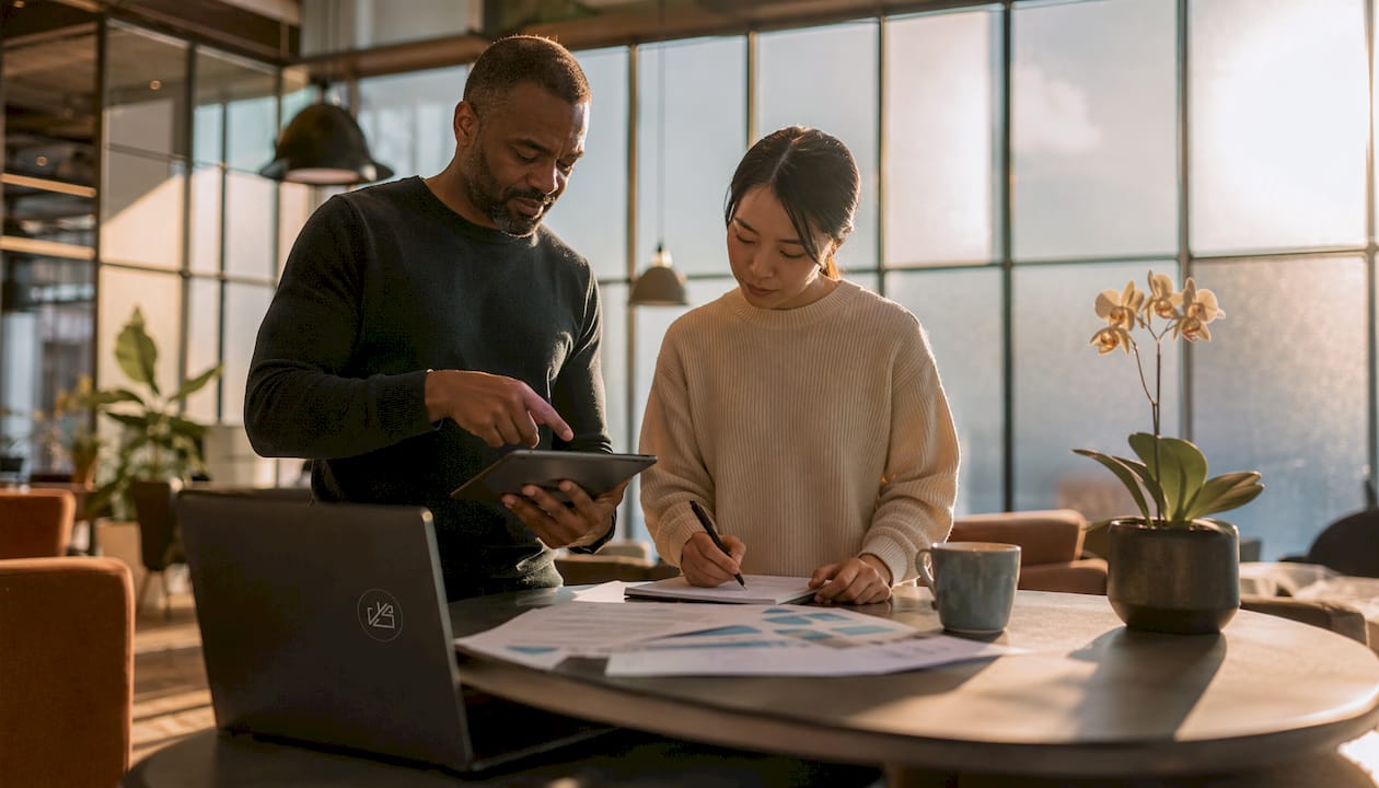 Two colleagues collaborating using AI tools
