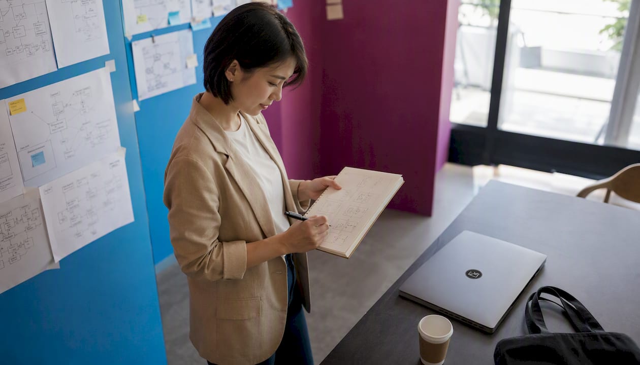 Woman sketching Microsoft AI workflows in office