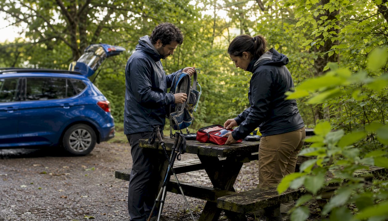 Hikers checking safety supplies before hike
