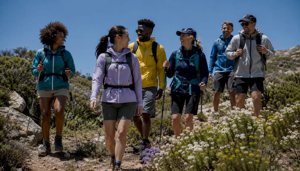 Diverse group hiking together on forest trail