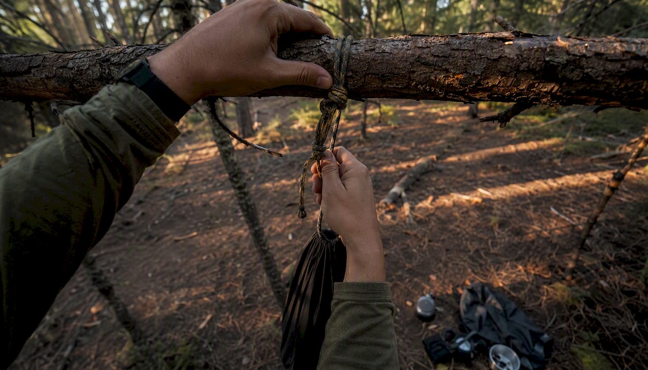 Bear bag hung from forest branch with knot tying
