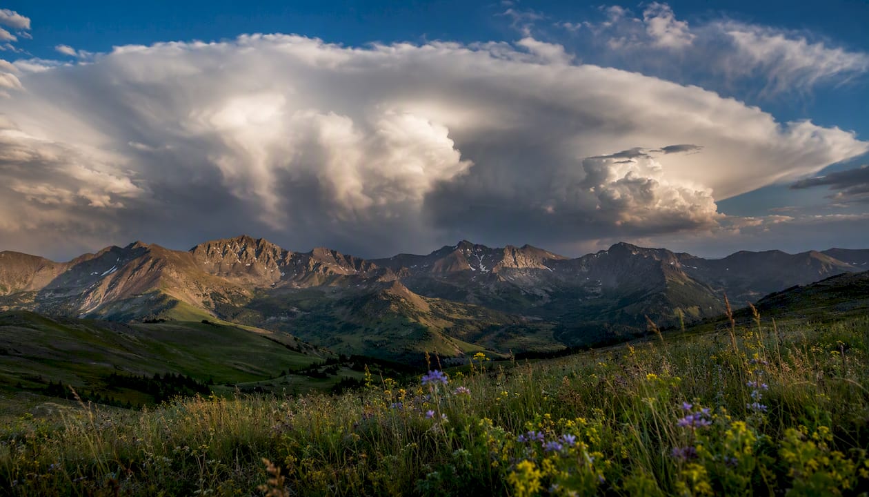 Anvil clouds above mountain ridge