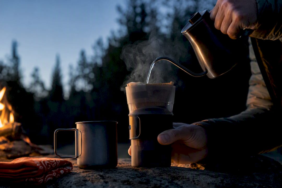 Brewing coffee at a forest campsite