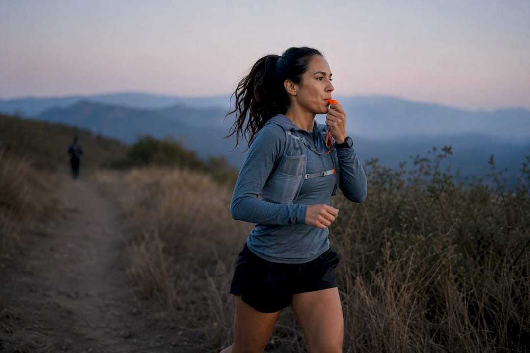 Runner using whistle on foothill trail