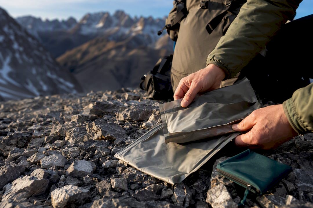 Hands staging a WAG bag kit outdoors