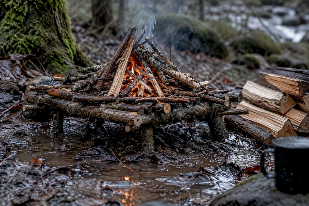 Raised stick platform above wet forest ground