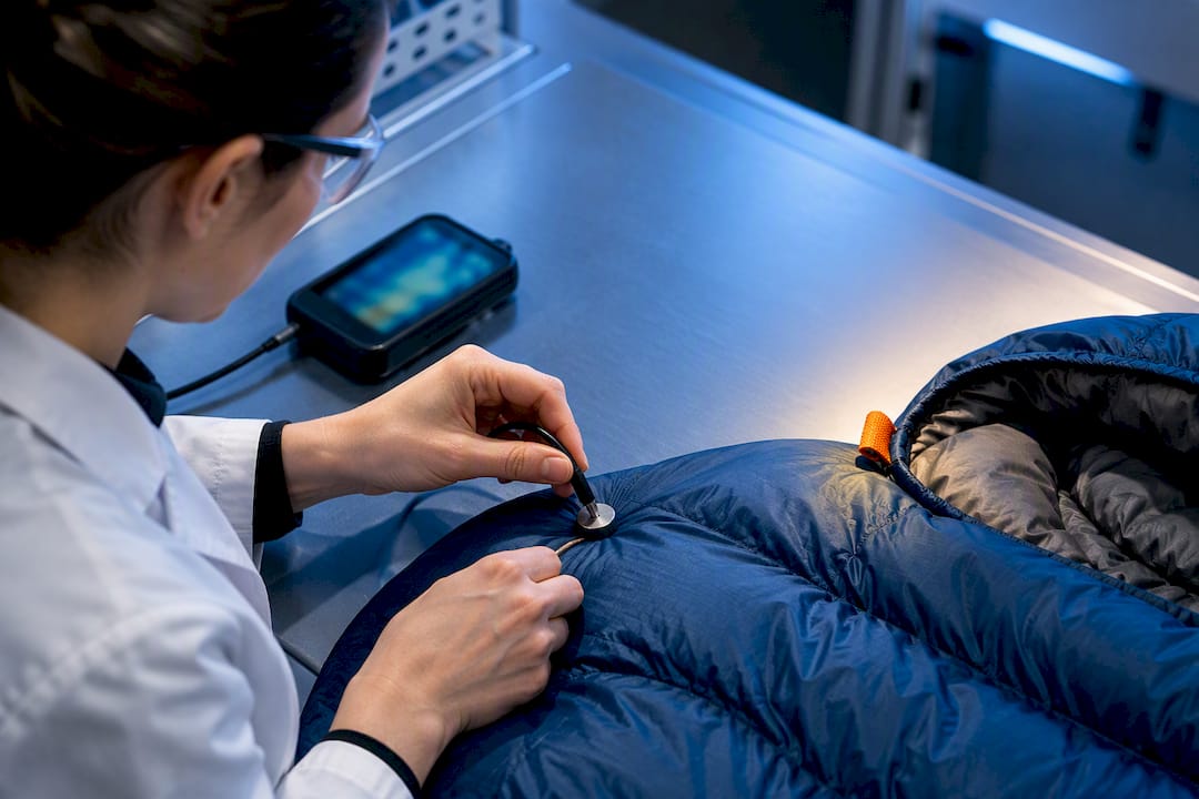 Technician checking sleeping bag temperature test