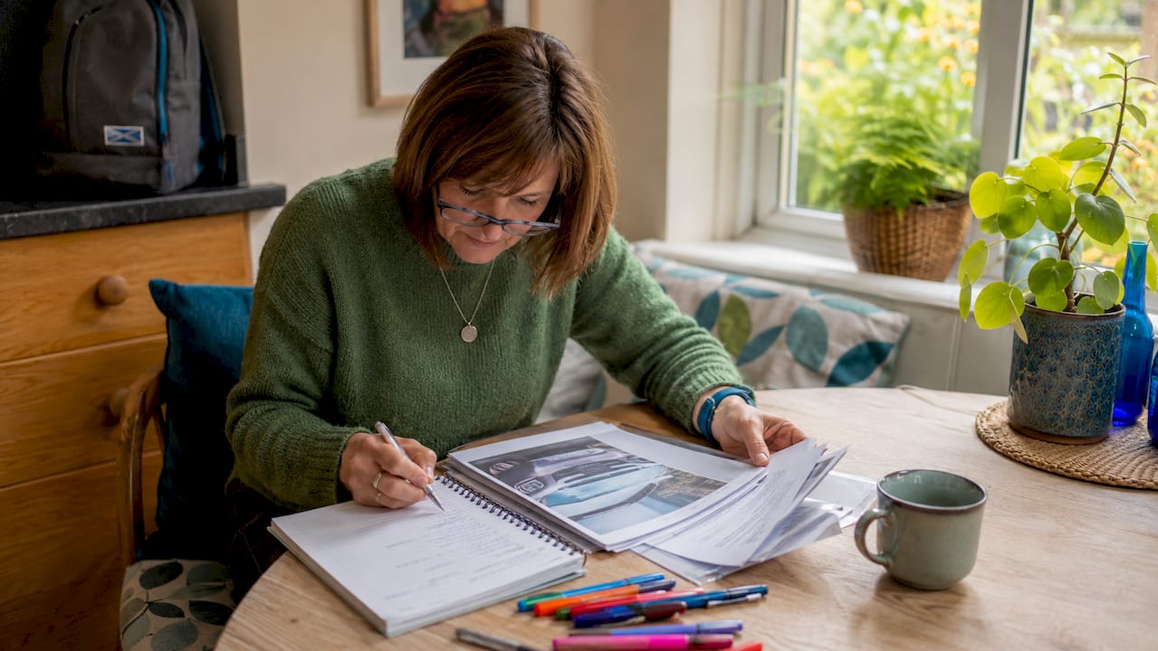 Scottish woman reviewing car accident claim paperwork