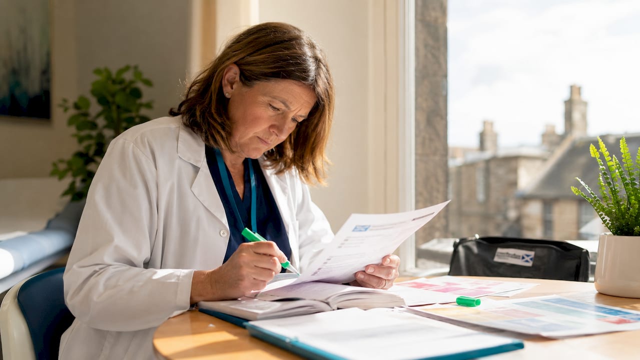 Doctor reviewing workplace injury documents