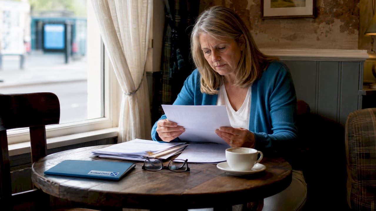 Woman reviewing medical negligence documents at home