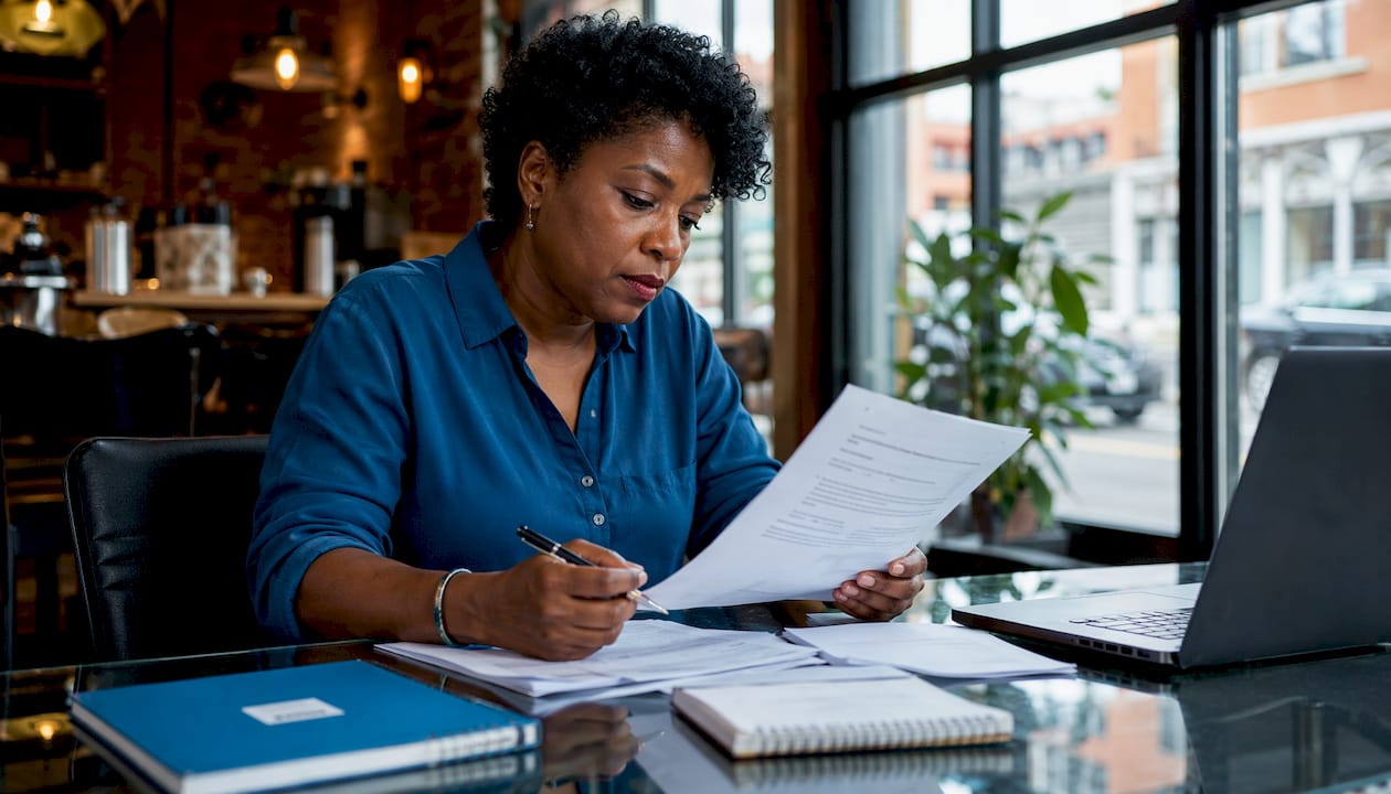 Woman reviewing divorce legal documents in home office