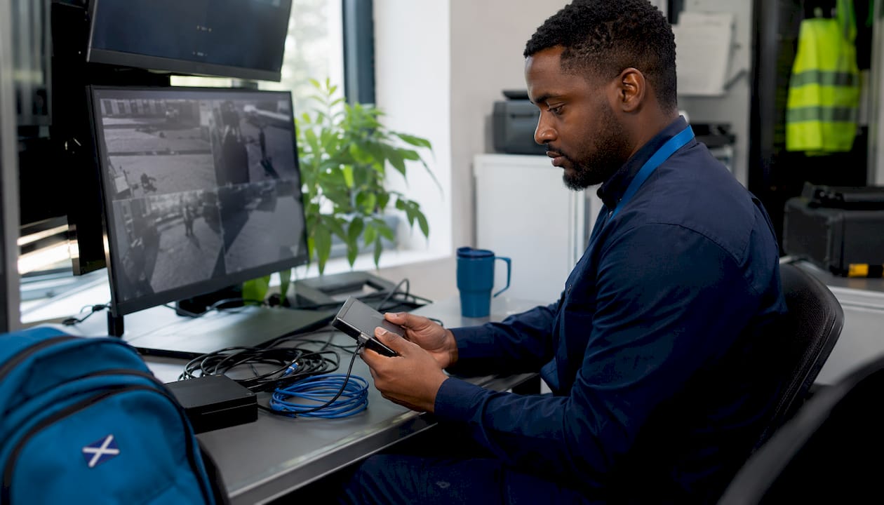 Technician handling CCTV evidence device
