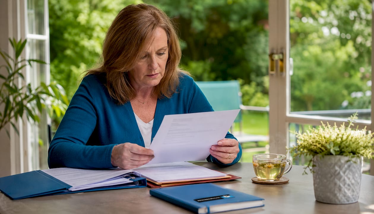 Woman reviewing workplace injury claim papers