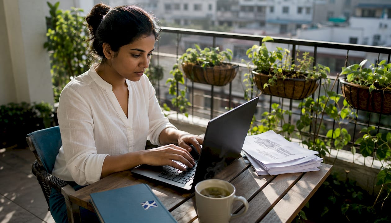 Woman calculating compensation claim at kitchen table
