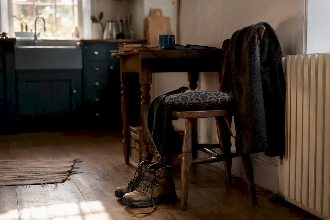 Empty chair and shoes in dim room
