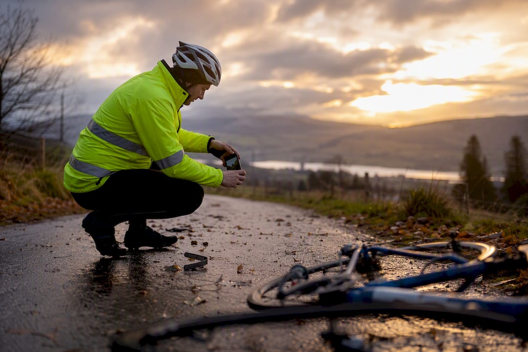 Cyclist photographing crash scene details