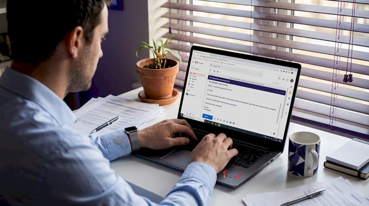 Man responding to customer email at desk