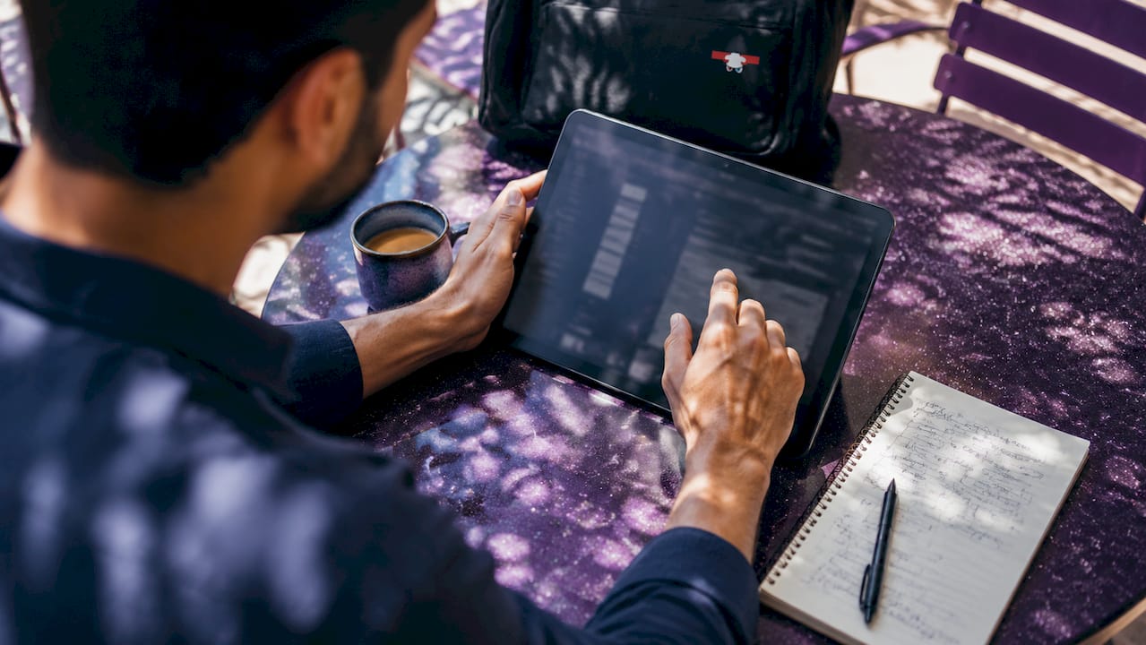 Hands adjusting programmatic advertising real-time bidding settings