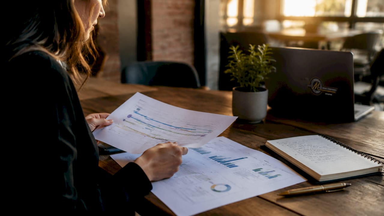 Hands reviewing investment recovery strategy charts