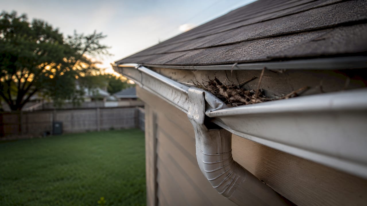 Gutter showing minor dents and debris after storm