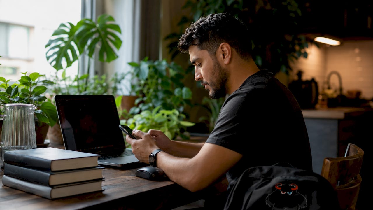 Web developer testing website on smartphone