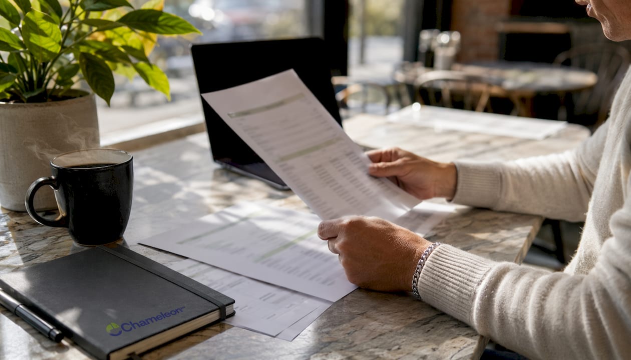 Hands reviewing telehealth pricing sheets on table