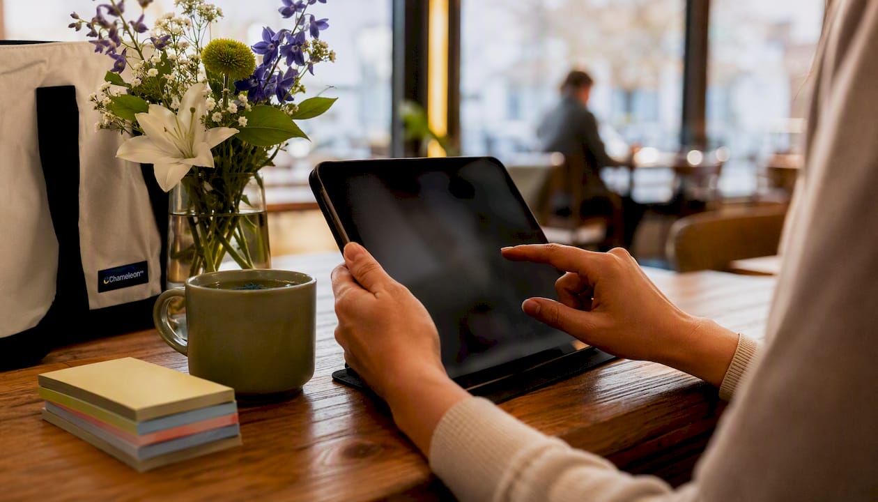 Hands using tablet for telehealth triage at home desk