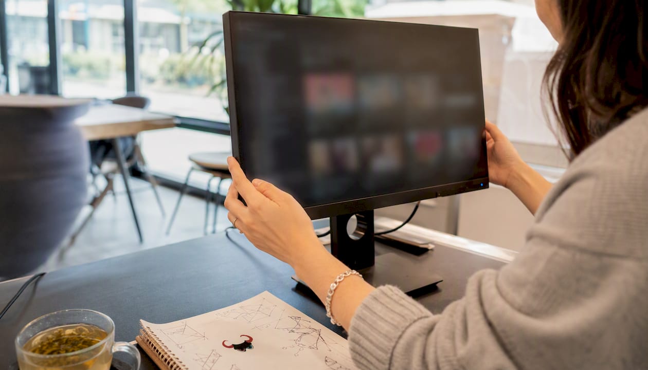 Hands managing digital brand assets on computer