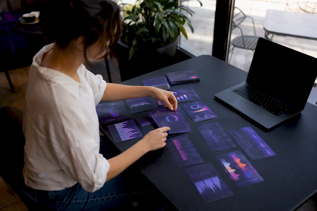 Hands arranging data visualization cards