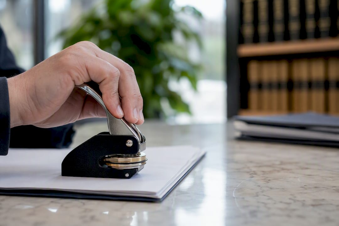 Notary public applying embossed seal