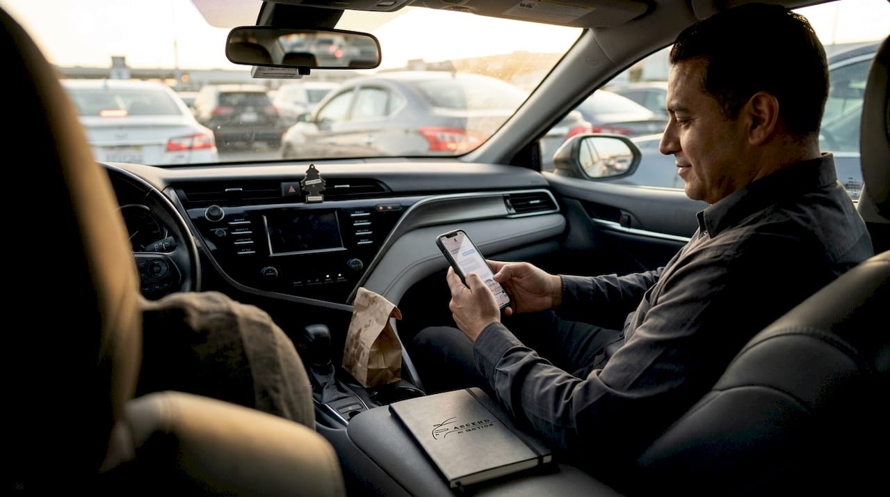 Chauffeur waits at LAX Cell Phone Lot in car