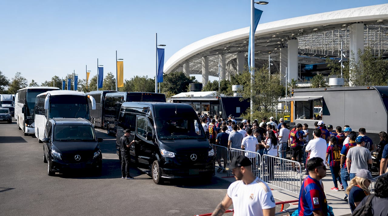 Metro shuttle bus stop with fans outside SoFi Stadium