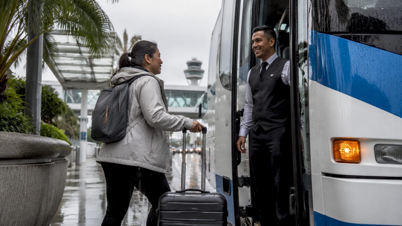Passenger boarding FlyAway bus at LAX stop