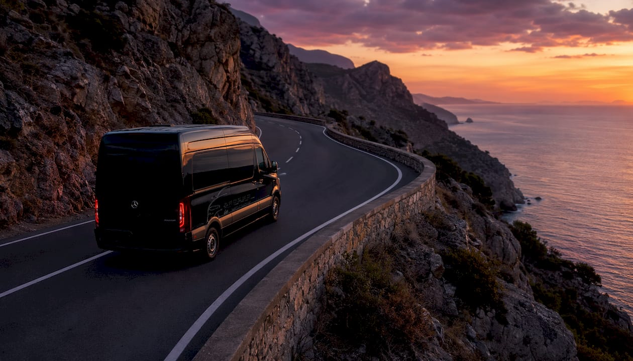 Ascend branded black minivan driving through Hollywood Hills