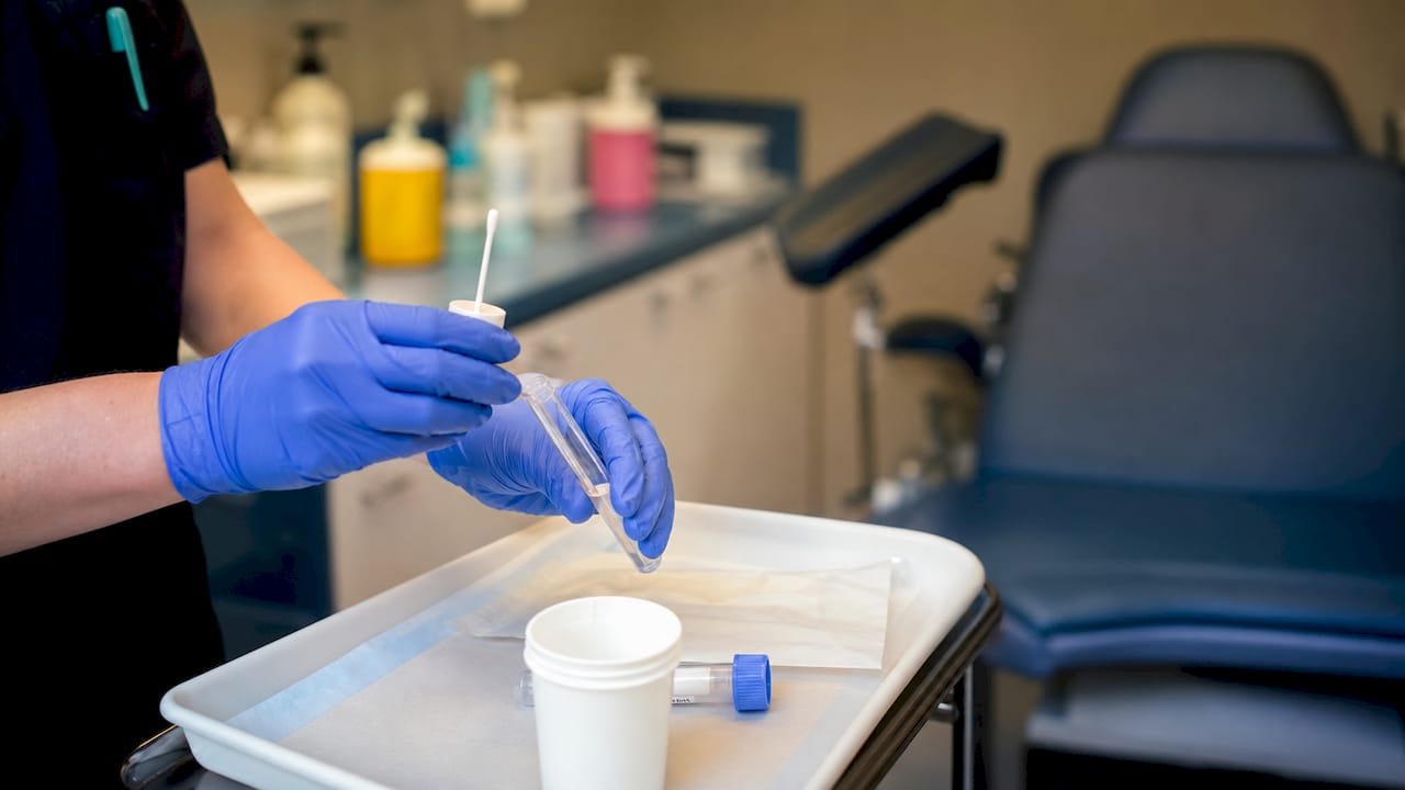 Mâini care pregătesc un set pentru testul de screening cervical