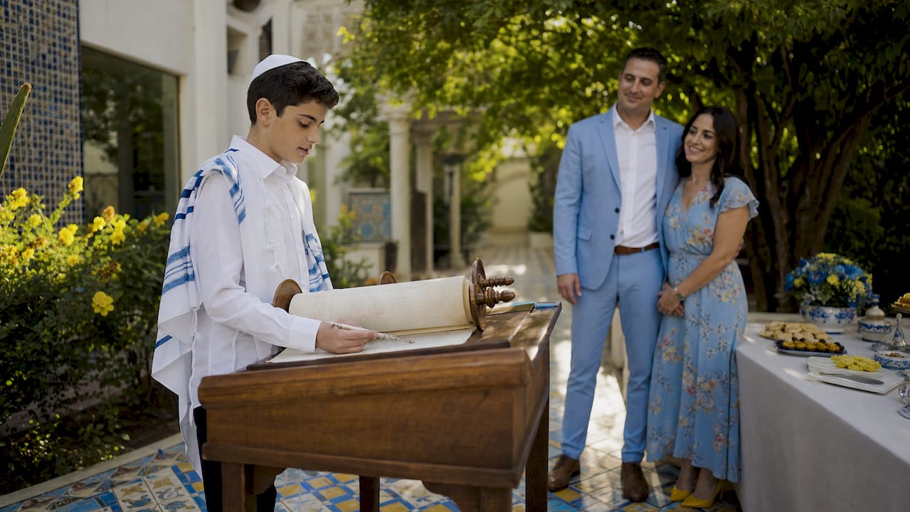 Sephardic family practicing Bar Mitzvah Torah reading