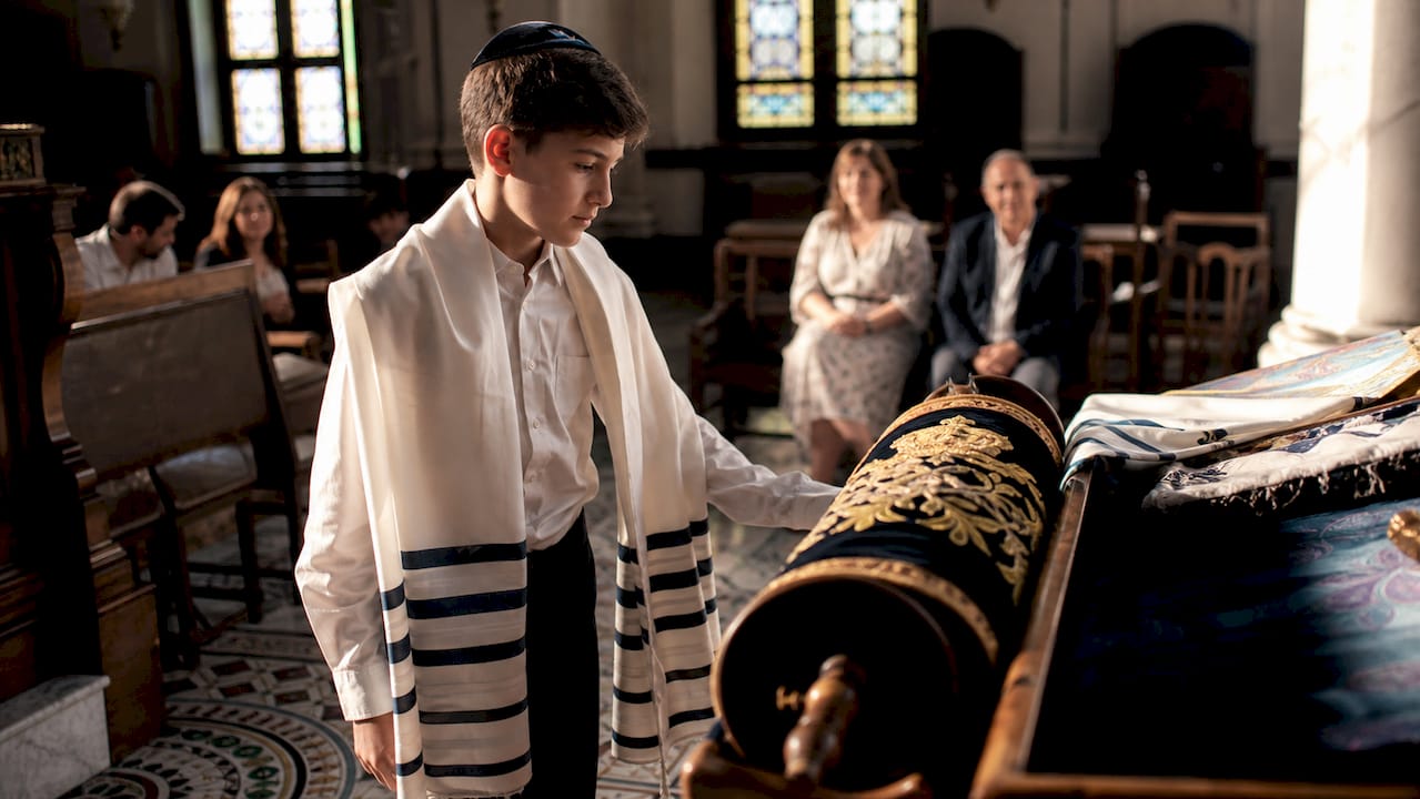 Bar mitzvah boy at Torah with mosaic floor