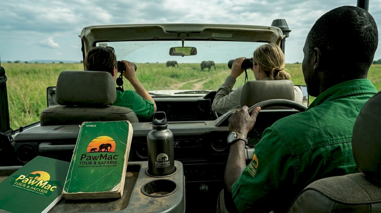 Guide and tourists on Uganda game drive