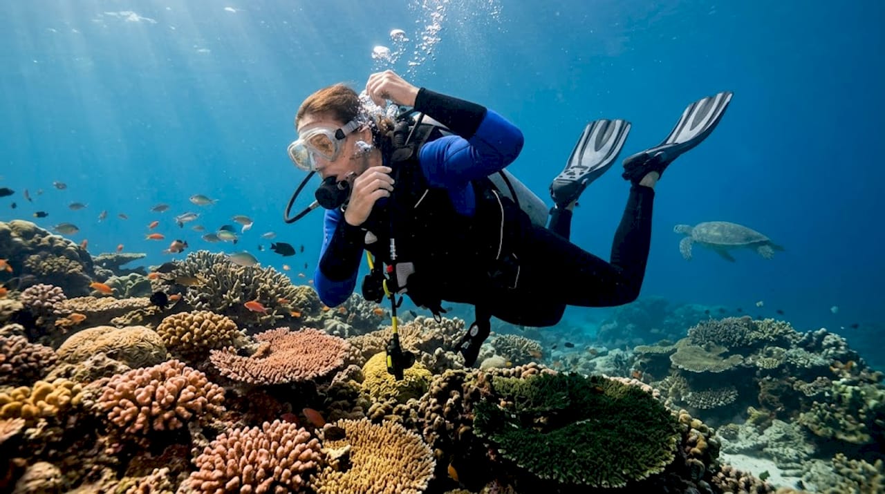 Diver practicing buoyancy above Bali reef