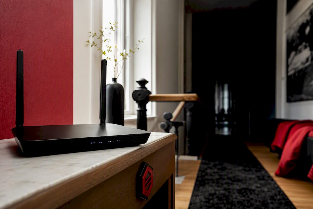 Anonymous router in shadowed Belgian home hallway