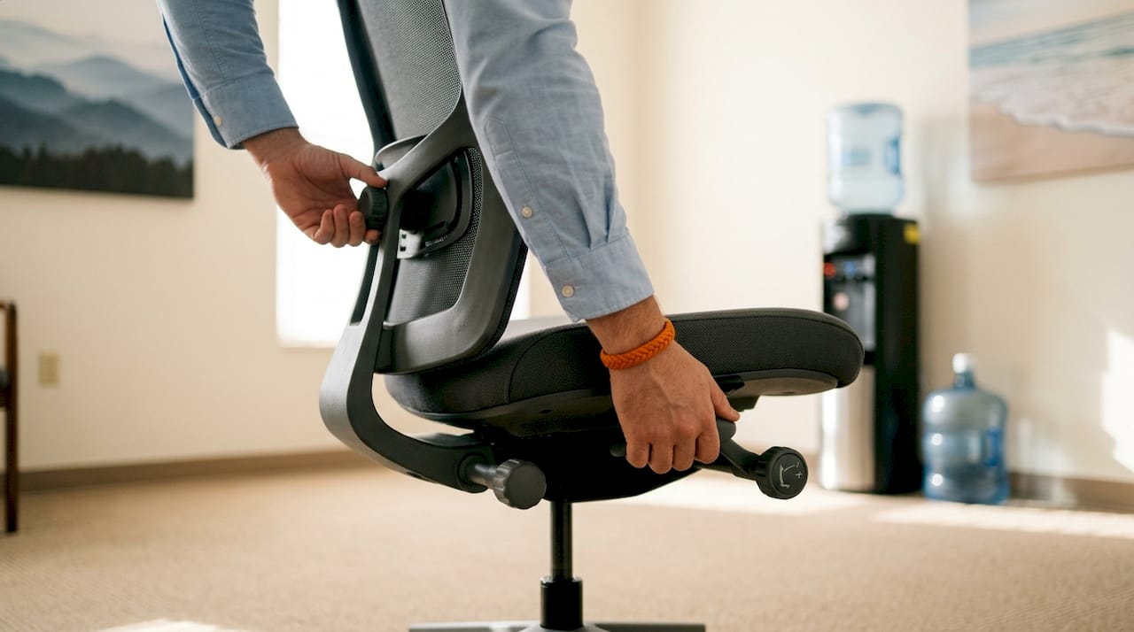 Hands adjusting ergonomic healthcare chair controls