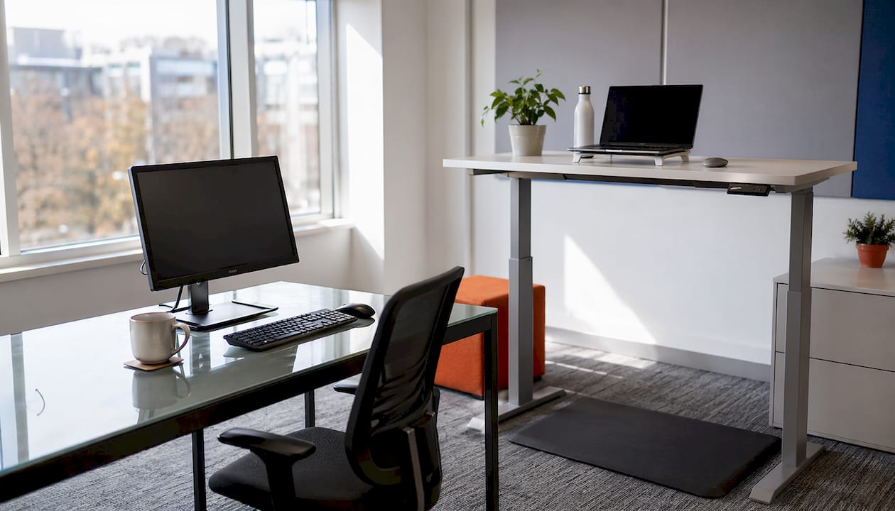 Close-up comparison of traditional and sit-stand desks