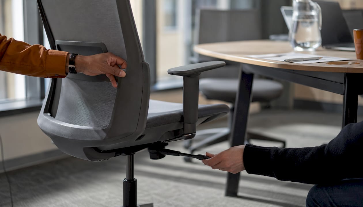 Hands adjusting ergonomic office chair